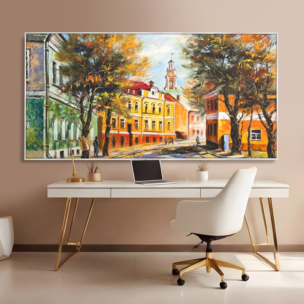 Tablou canvas cu pictura stradala cu peisaj de toamna, in rama de aluminiu argintiu, pe perete intr-un birou